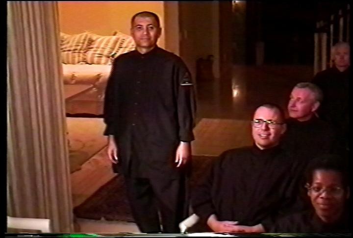 People gathered indoors in archival footage