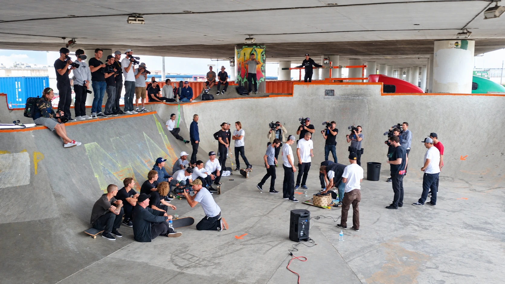 Camera crews and skateboarders gathered inside a skate bowl during King of the Road production.