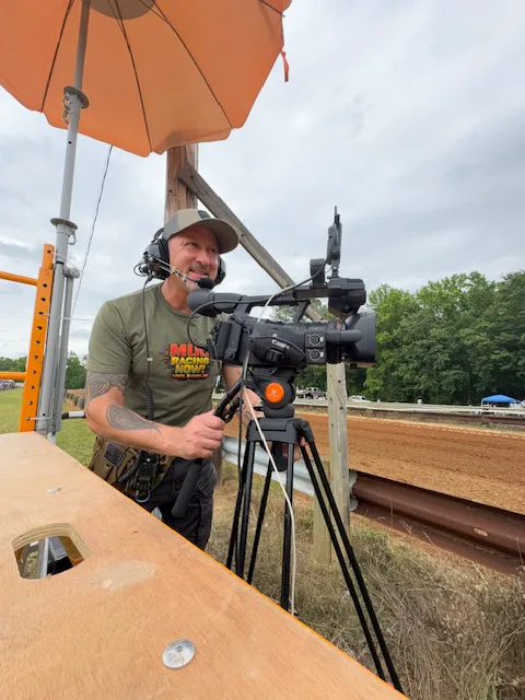 Sergio Myers operating a trackside camera for Mud Racing Now